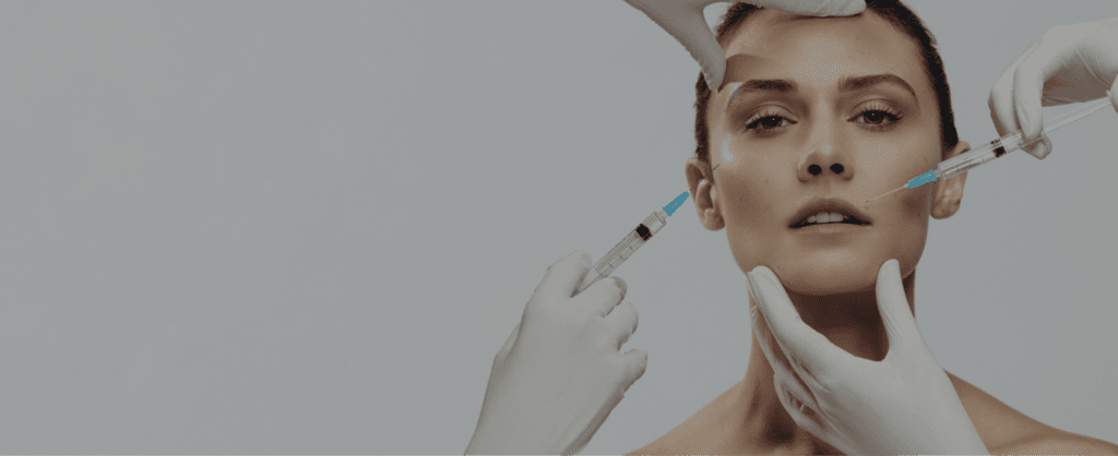A woman receiving aesthetic injections for facial enhancement.