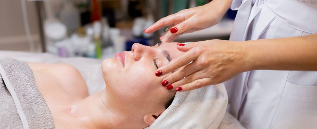 Woman receiving a relaxing facial massage.