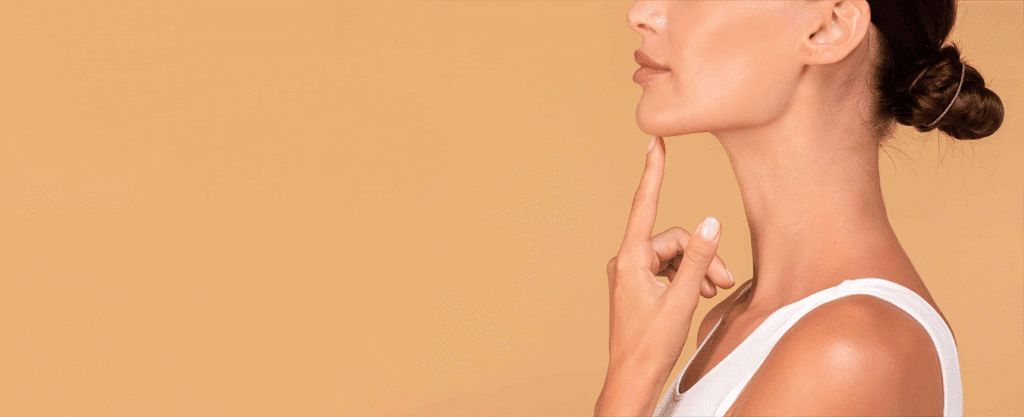 A woman with a thoughtful expression, gently touching her chin.