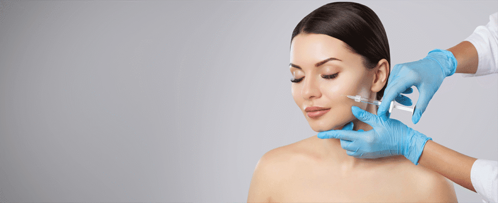 Dermal filler injection being administered to the cheek area by a medical professional for facial contouring and rejuvenation.