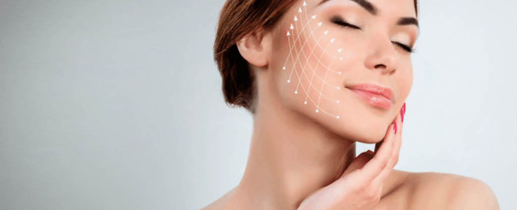 A smiling woman with her eyes closed and hand on her face, featuring a white dashed grid and arrows on her cheek to illustrate a thread lift or contouring procedure.
