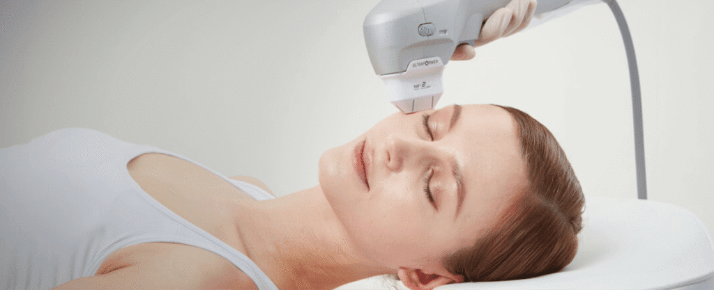 Patient receiving HIFU treatment on the cheek and jawline area.