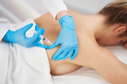 Body contouring injection being administered to the lower back.