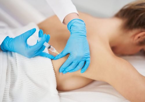 Body contouring injection being administered to the lower back.