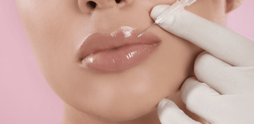 Specialist administering lip filler injection.